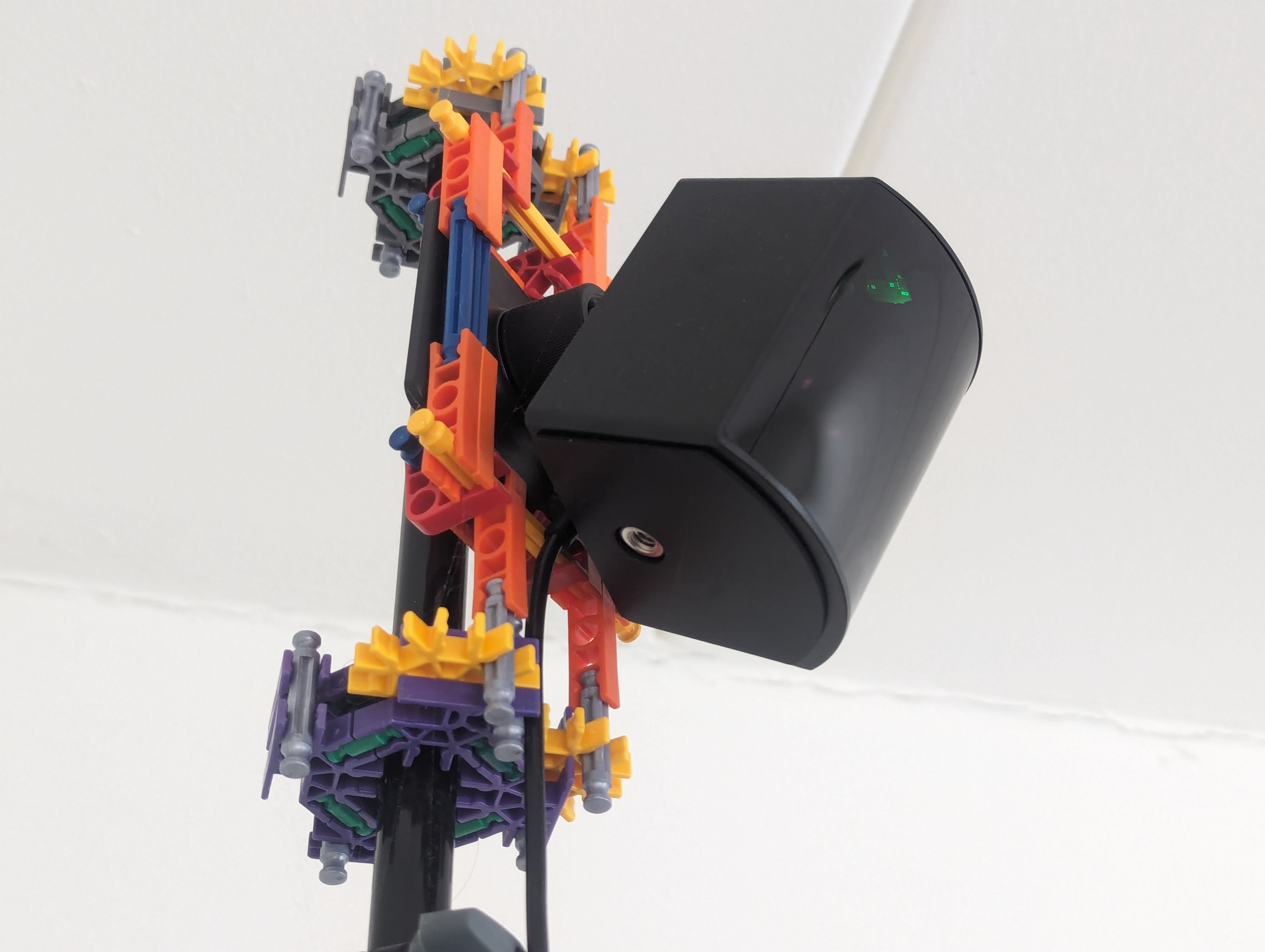 A K'nex bracket holding a base station onto the top of a tripod