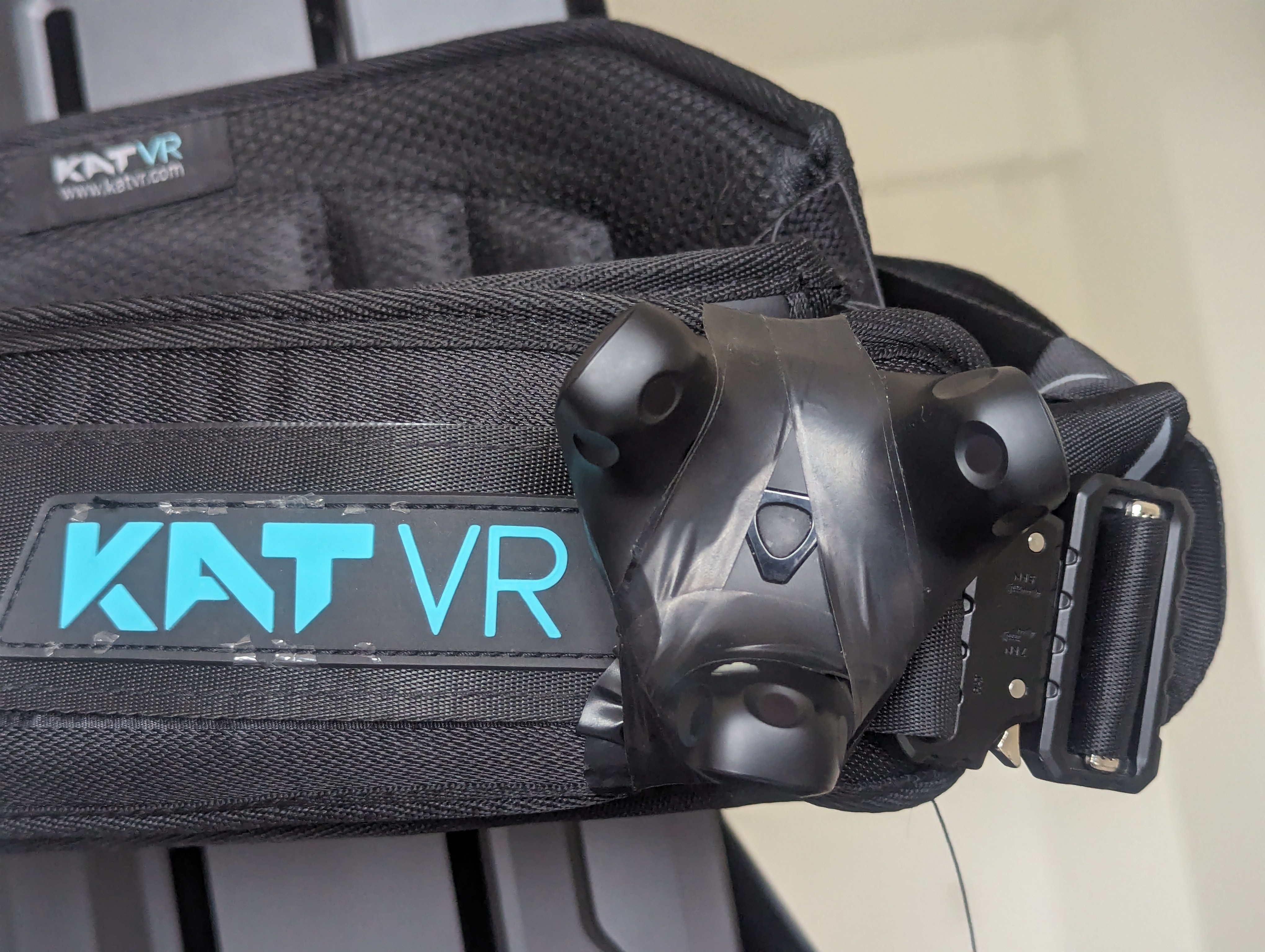 A vive tracker electrical-taped to the Kat Walk harness