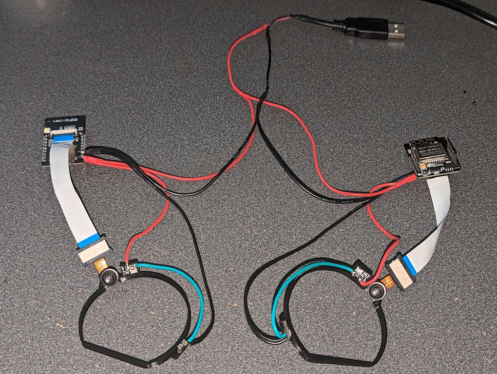 An assembled set of EyeTrackVR Eye trackers and associated wiring layed out on a desk